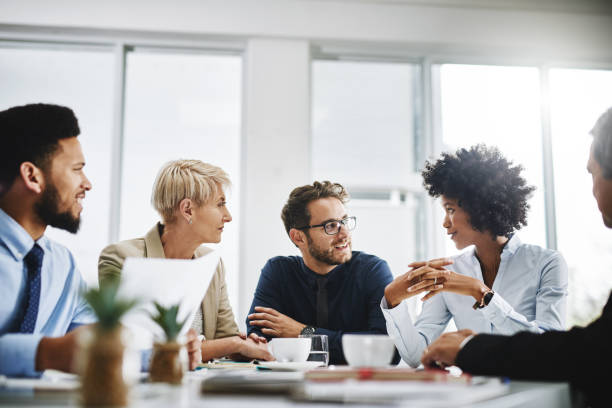 A group of business people sitting together and having a meeting in the office