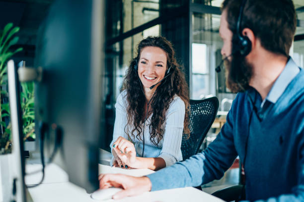 Two business employees enjoying working in a cloud call center